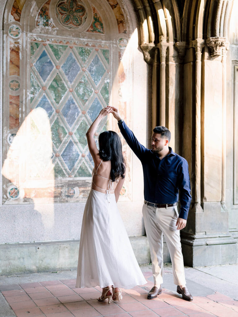 Engaged couple at iconic Bethesda Terrace Central Park with architectural arches