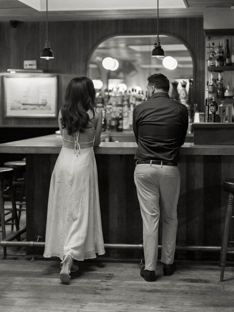 Intimate engagement moment beneath Bethesda Terrace carved stone arches NYC