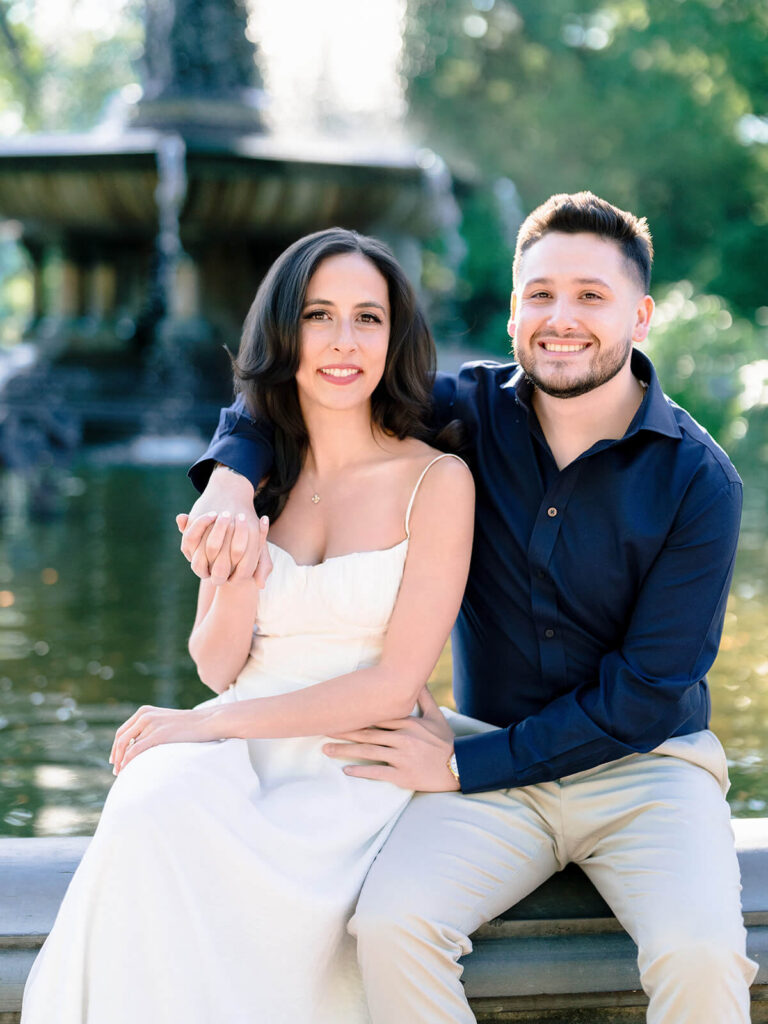 Romantic engagement photos beneath Bethesda Terrace arches with natural light