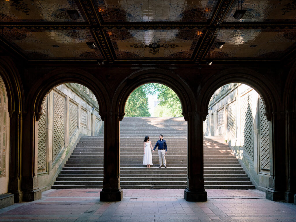 Romantic Central Park engagement at Bethesda Terrace looking through arcade arches