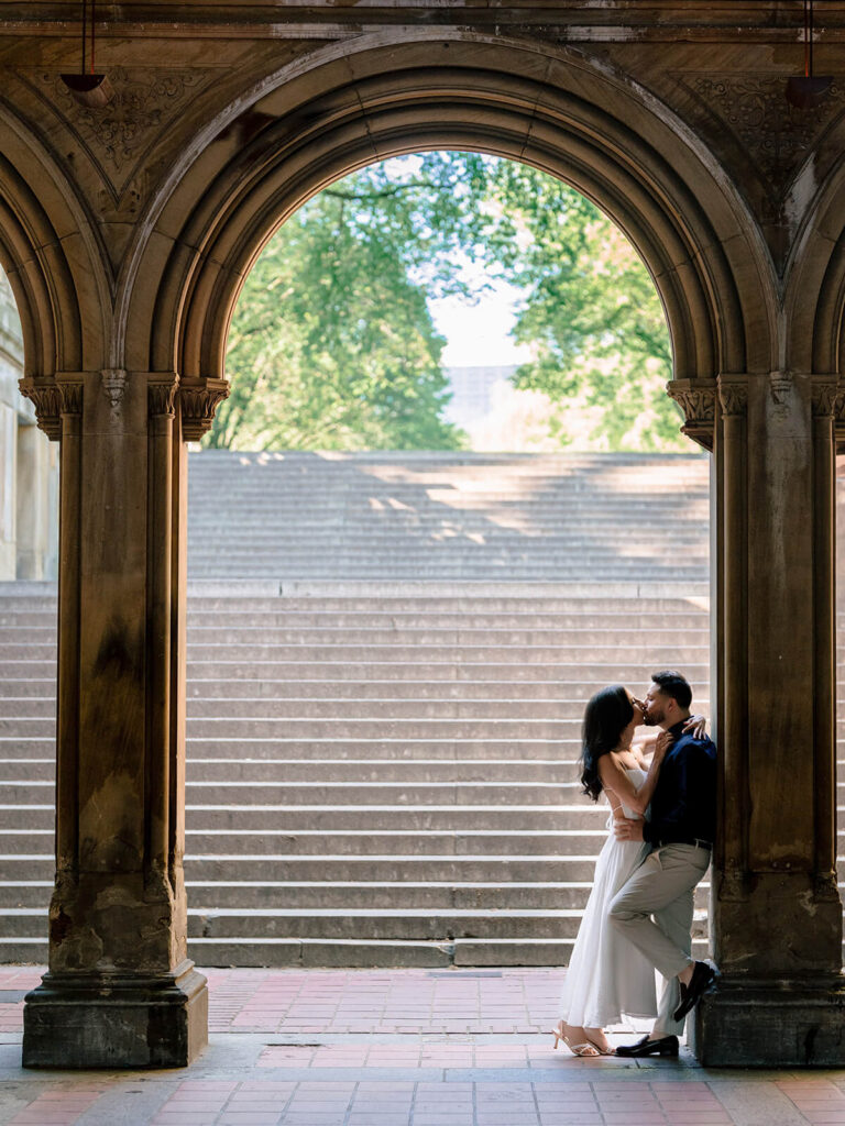 NYC engagement photos at Bethesda Terrace fountain plaza with architectural details
