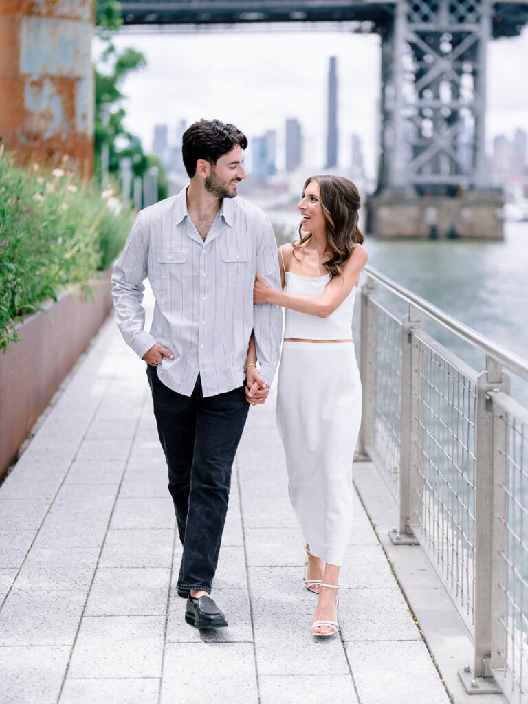 Couple portrait with Williamsburg Bridge backdrop at Brooklyn engagement party photo session