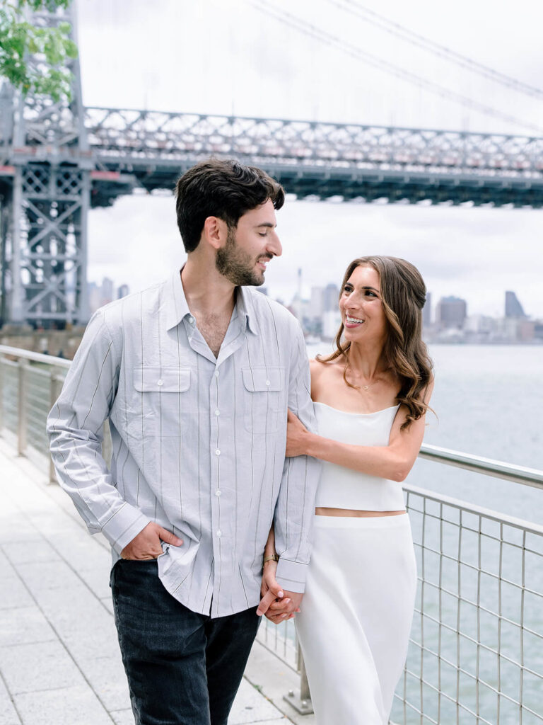 Brooklyn engagement photos at Domino Park waterfront with Manhattan skyline views