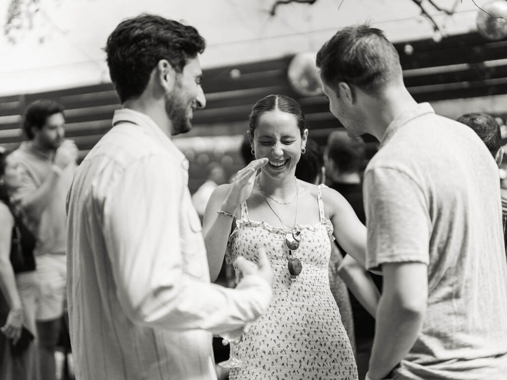 Outdoor garden engagement party photos at Brooklyn venue with guests celebrating