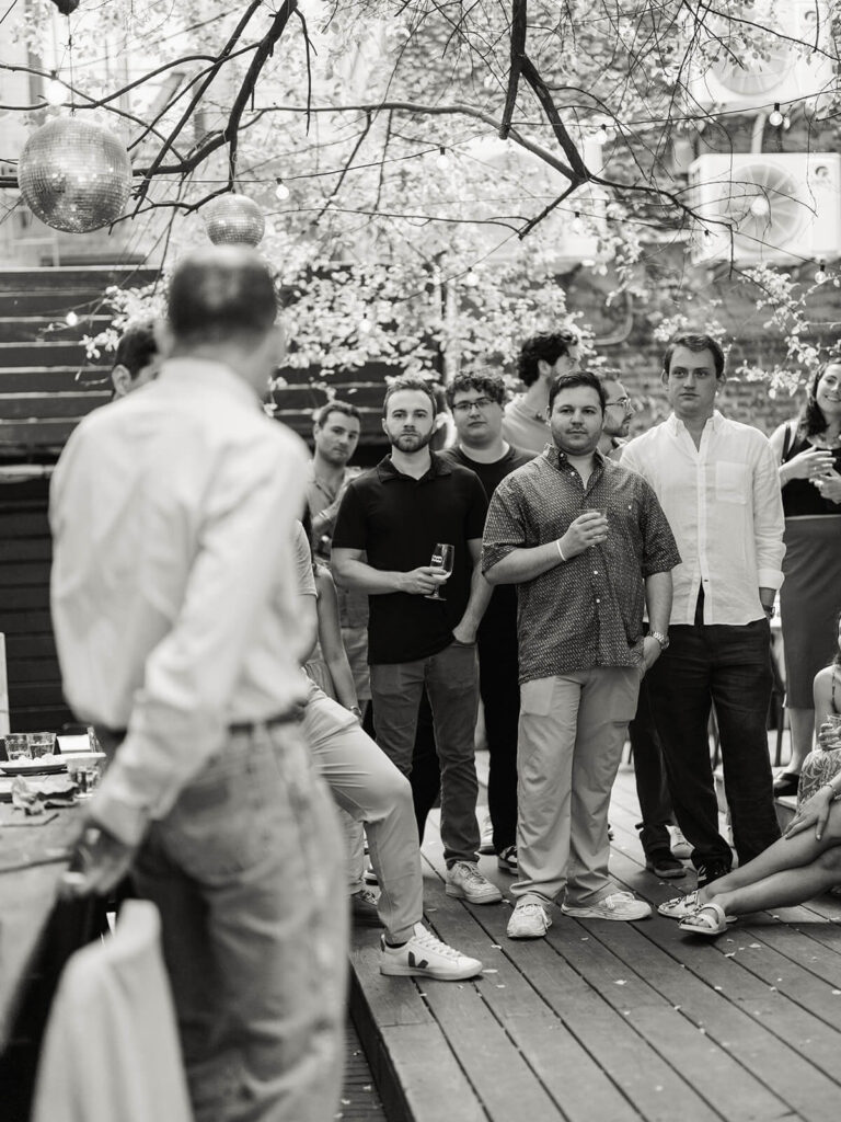 Engagement party photography at Sauced Brooklyn garden venue with string lights