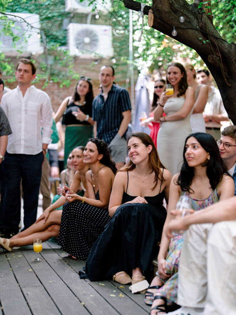 Brooklyn engagement celebration candid photos at outdoor garden party venue