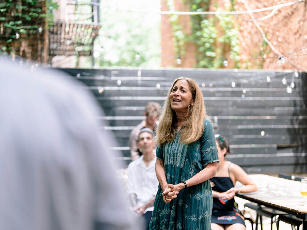 Candid engagement party photography Brooklyn at rustic garden celebration venue