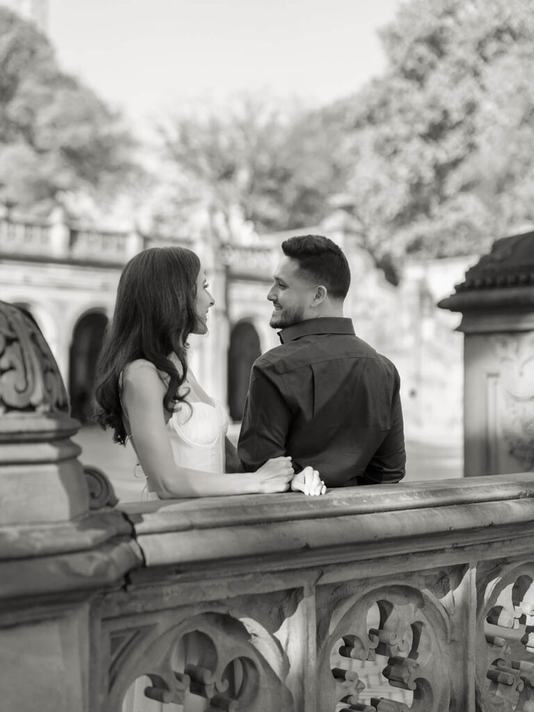 Couple celebrating with drinks during NYC bar engagement photography session