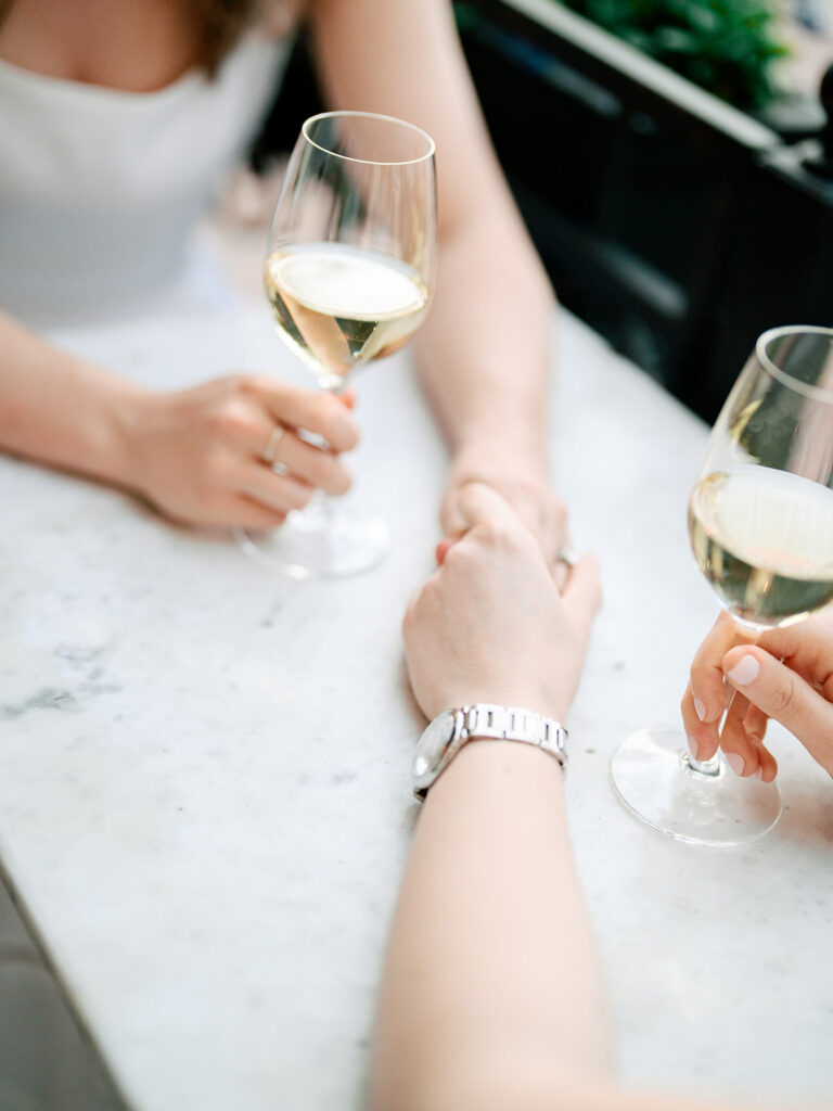 Two brides walking hand-in-hand through South End Boston brownstone neighborhood