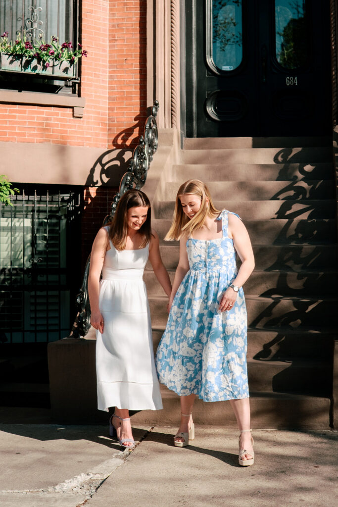 Engaged couple sitting on black iron bench in South End Boston tulip garden