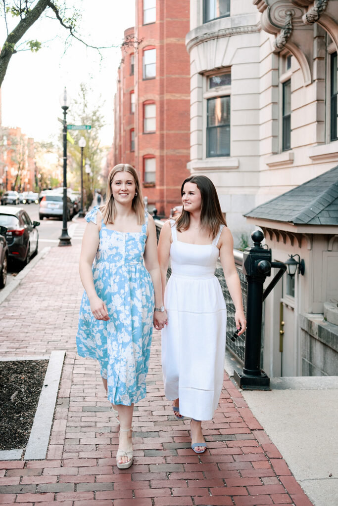 Two brides walking through blooming tulip gardens during South End Boston engagement