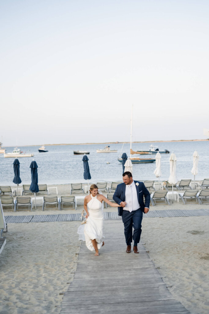 Bride and groom embracing on the shoreline in Chatham, Massachusetts