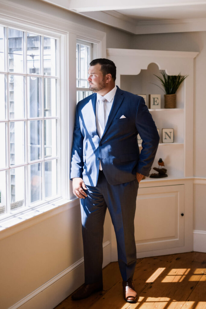 Groom portrait by the window before his Chatham Bars Inn wedding on Cape Cod