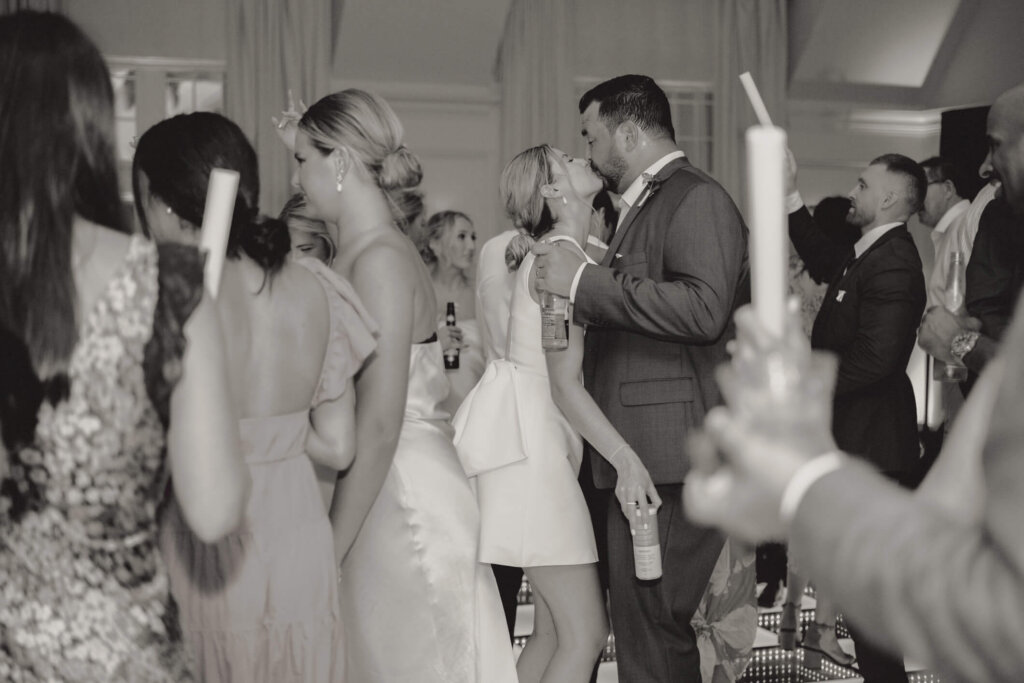 Nighttime celebration as guests cheer for the couple outside Chatham Bars Inn