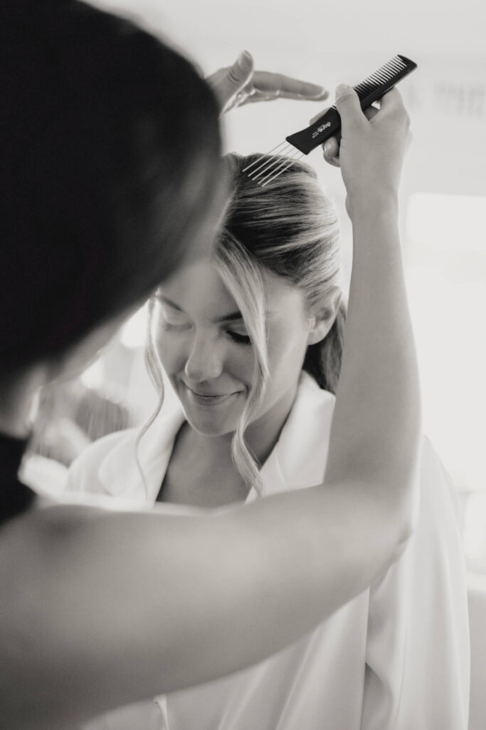 Bride getting ready in a white robe before her Chatham Bars Inn wedding on Cape Cod