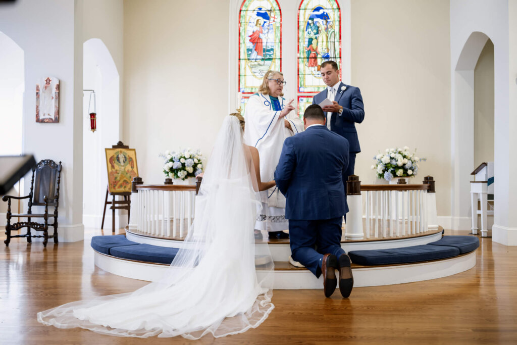 Bride and groom smiling during their ceremony at St. Christopher’s Episcopal Church