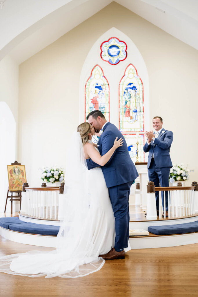 Bride and groom holding hands at the altar during their Cape Cod church ceremony