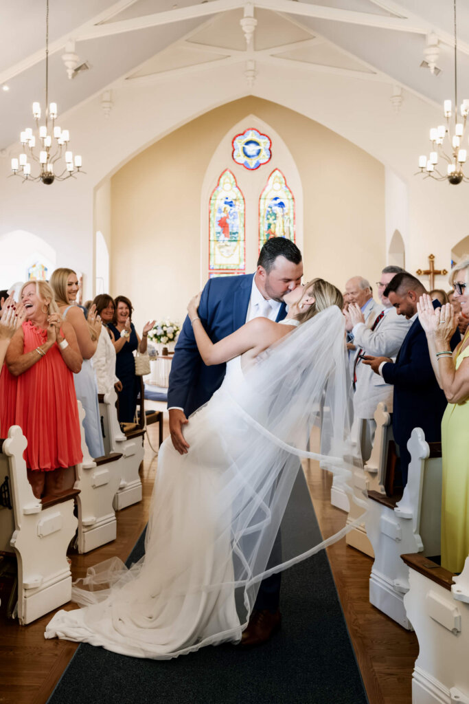 Bride and groom walking back up the aisle after their ceremony in Chatham