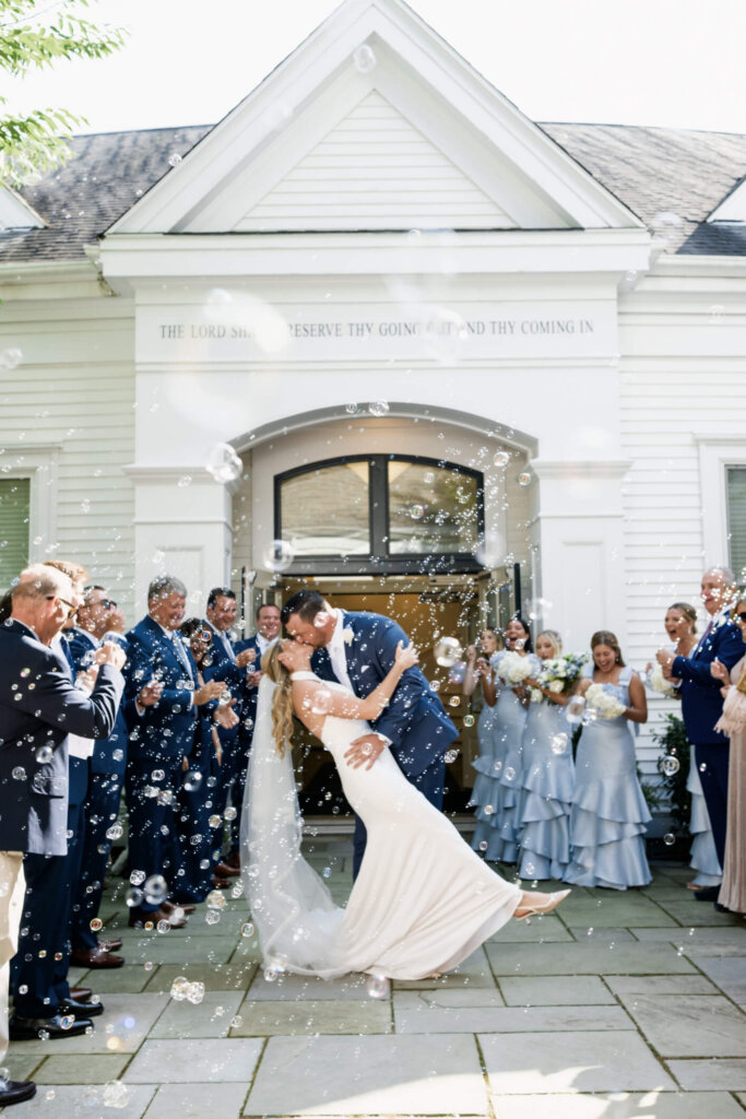 Bride and groom celebrating outside St. Christopher’s Episcopal Church in Chatham