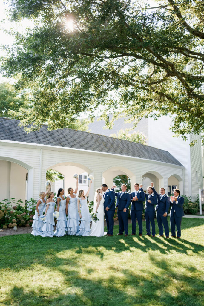 Bride and groom kissing in the backseat of their just married getaway car in Chatham