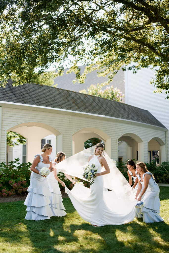 Bride and groom portrait beneath white lattice arches at Chatham Bars Inn