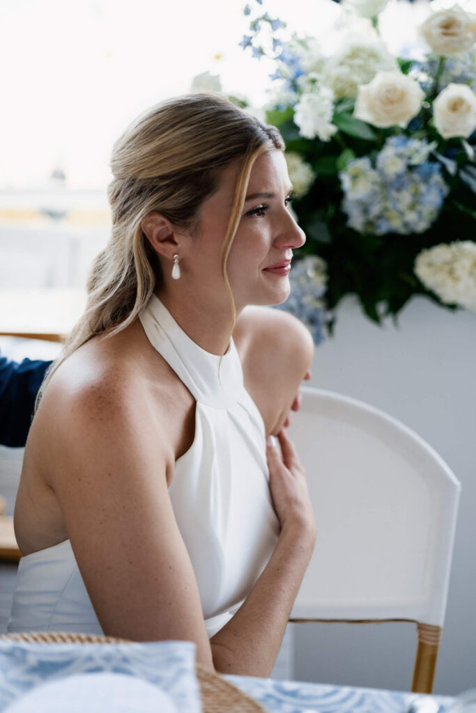 Bride listening during a reception toast at Chatham Bars Inn on Cape Cod