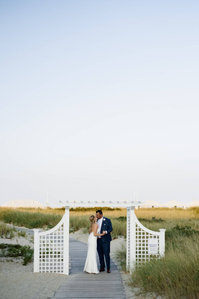 Bride and groom portrait by the white arches in the dunes at Chatham Bars Inn
