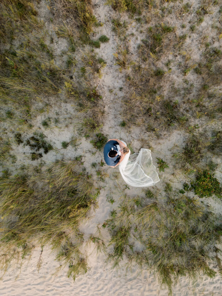 Aerial portrait of the bride and groom in the dunes at Chatham Bars Inn
