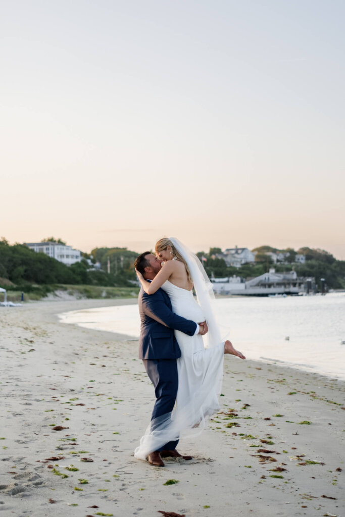 Bride and groom embracing on the beach at Chatham Bars Inn in Chatham, Massachusetts