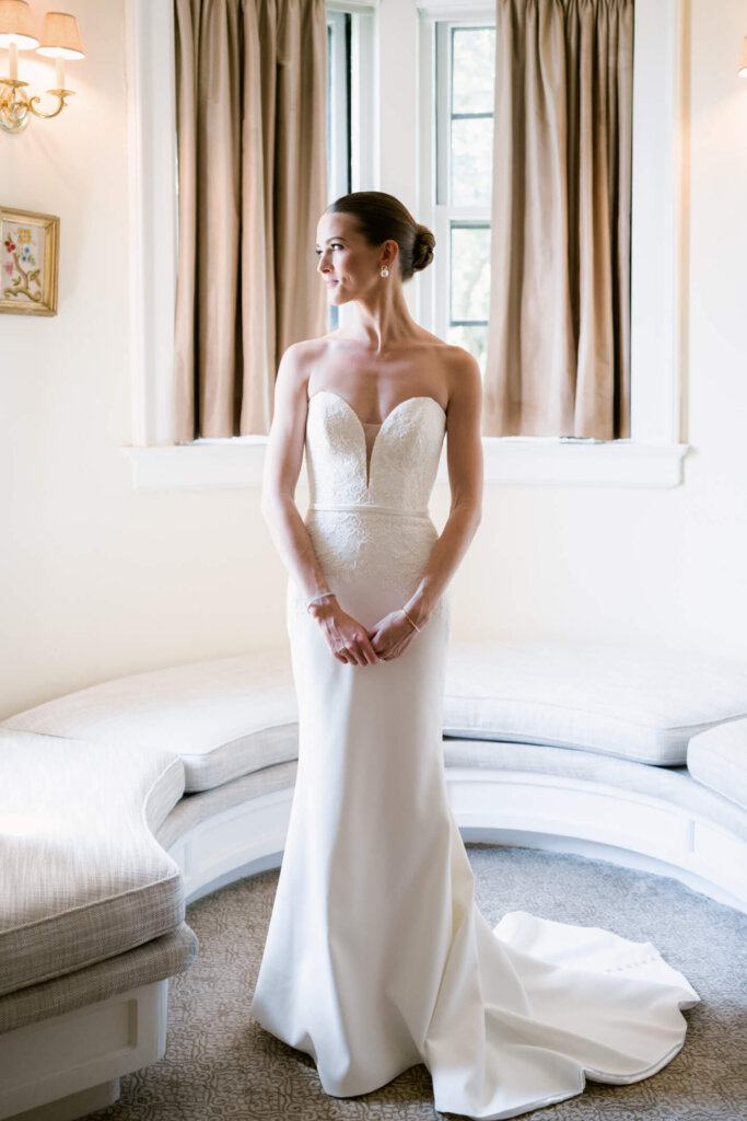 Bride stepping into her dress before the Bedford Golf and Tennis Club wedding