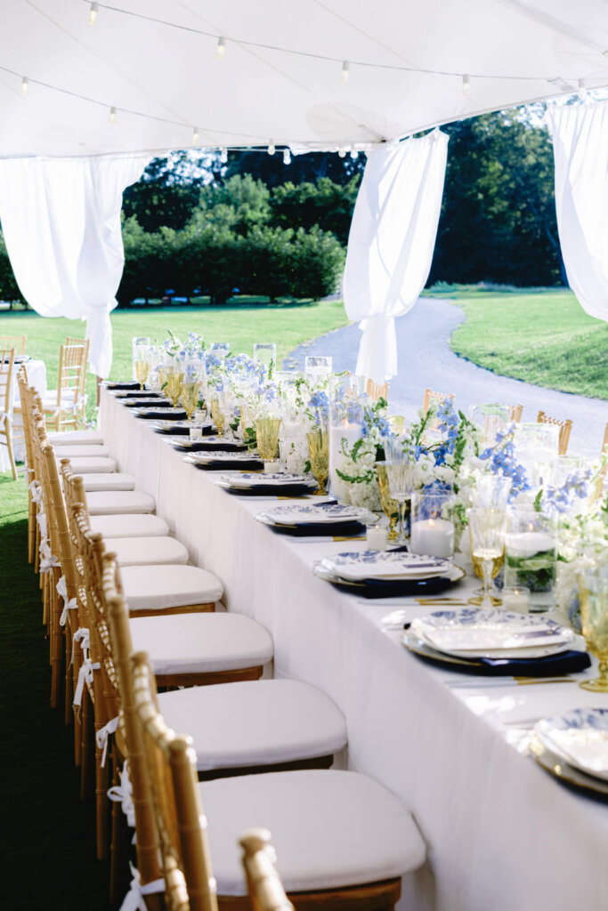 Long reception table with blue and white flowers at Bedford Golf and Tennis Club