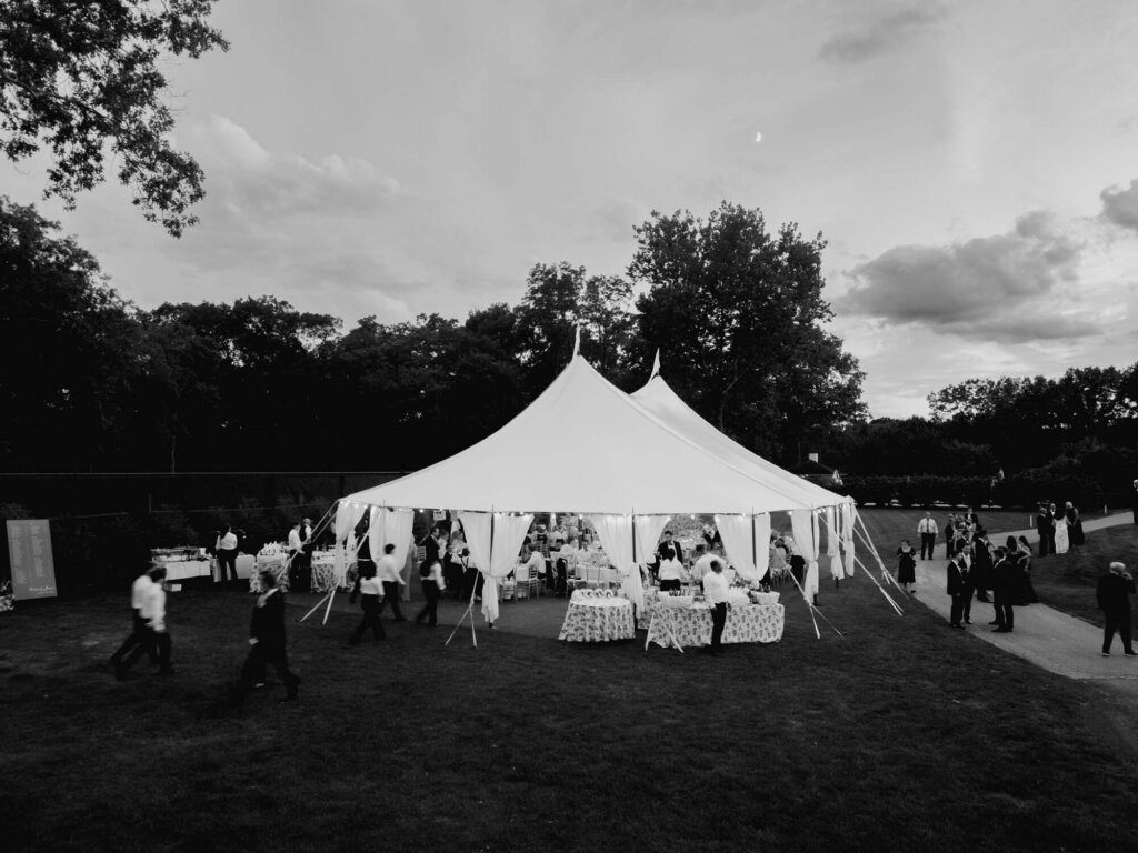 Bride and groom walking at sunset outside Bedford Golf and Tennis Club