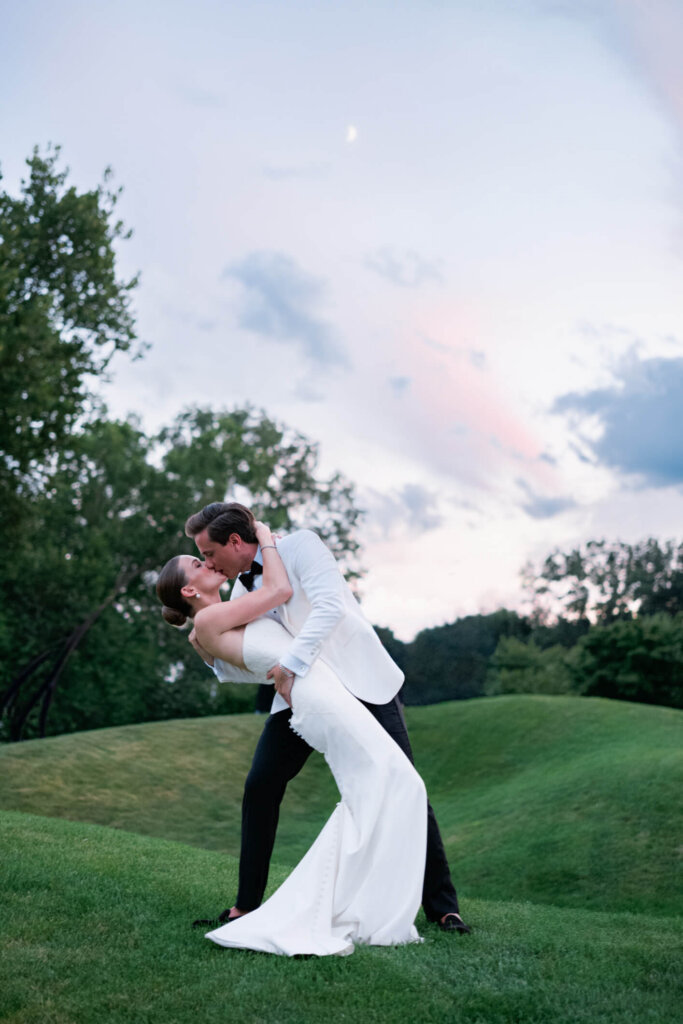 Bride and groom feeding each other cake at Bedford Golf and Tennis Club