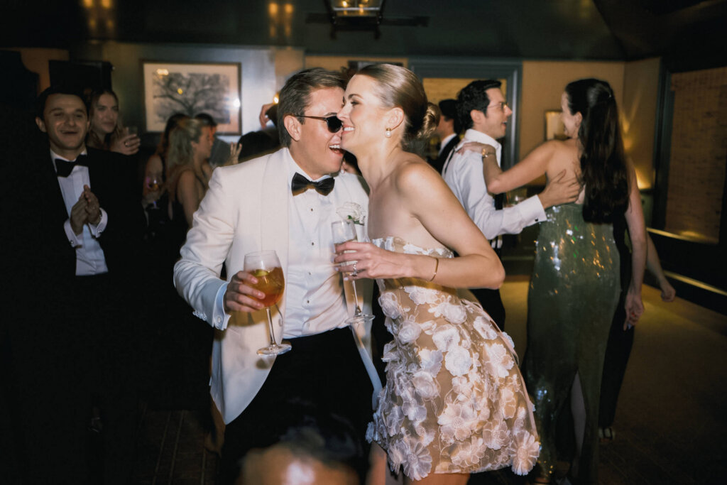 Bride and groom with firefighters during the after party in Bedford, New York