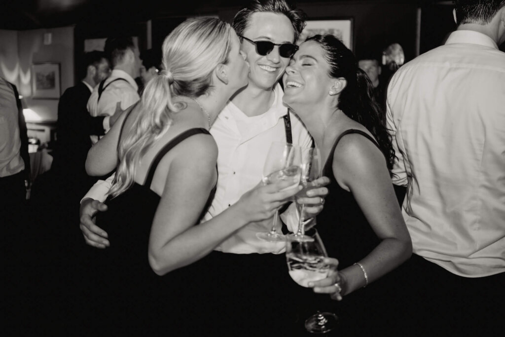Bride in her short dress with guests at Bedford Golf and Tennis Club after party