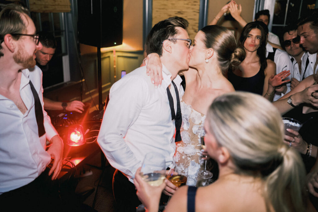 Bride holding her shoes during the Bedford Golf and Tennis Club after party