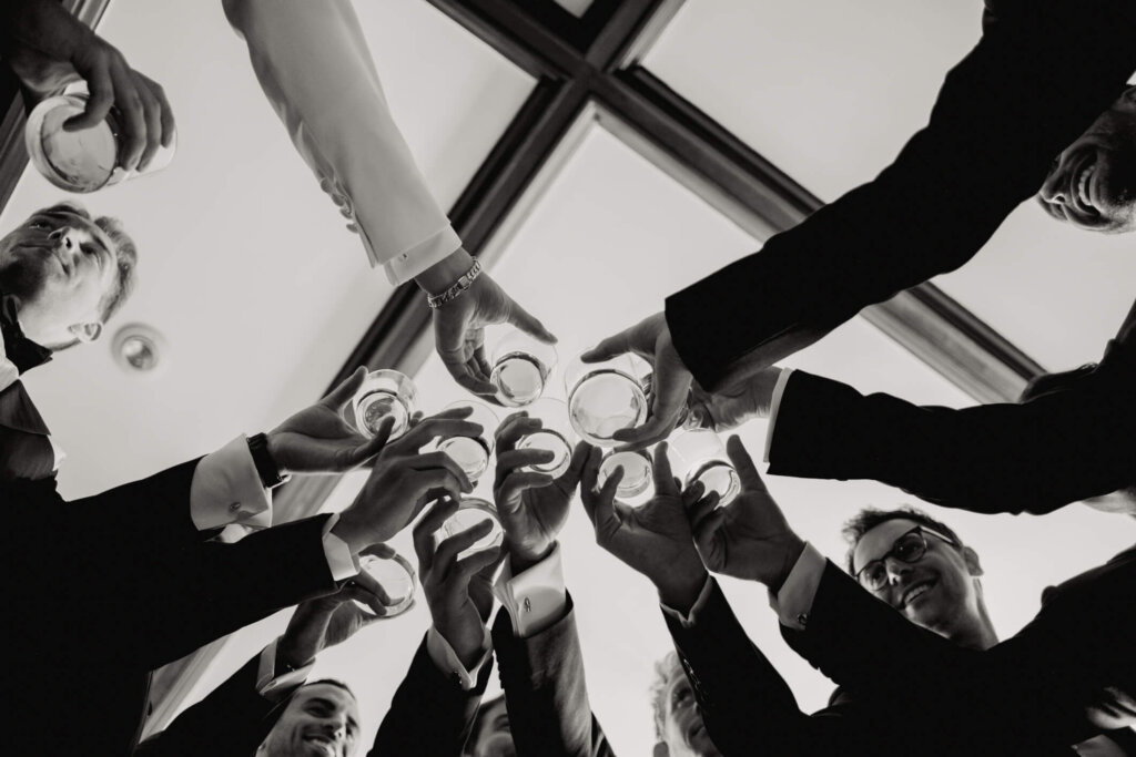 Groomsmen toasting before the Bedford Golf and Tennis Club wedding outside NYC