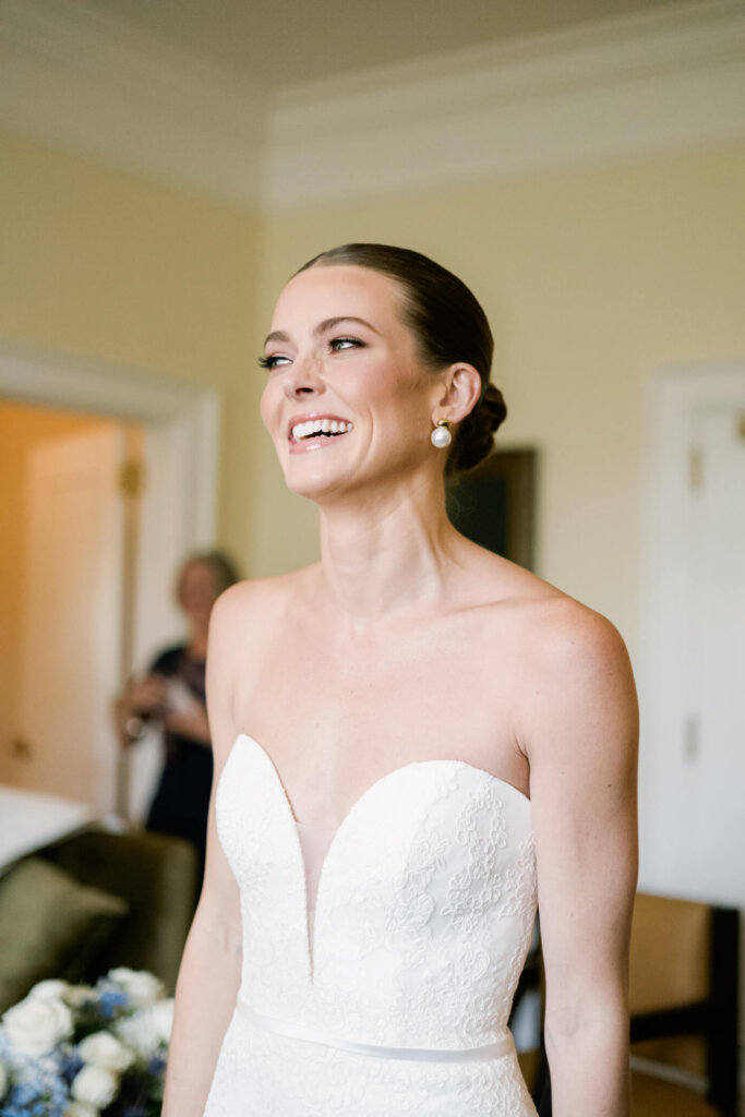 Bride portrait in front of the white building before the Bedford Golf and Tennis Club wedding