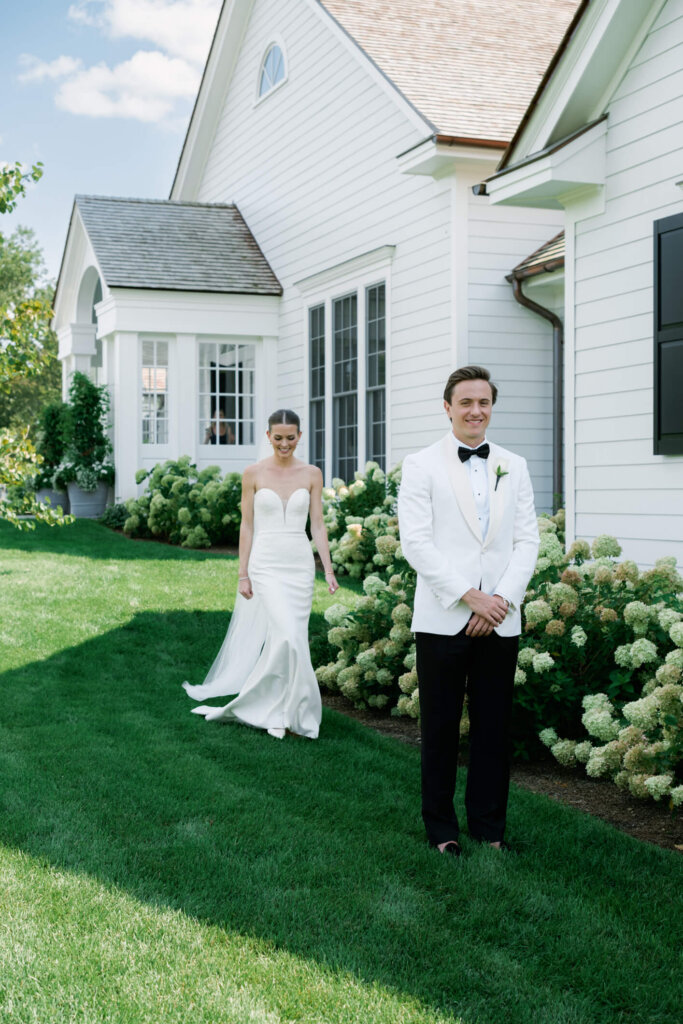 Bride and groom embracing during their first look in Bedford, New York