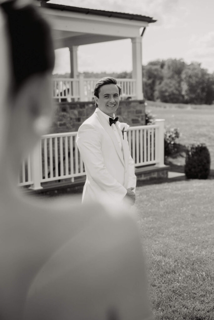 Bride and groom portrait outside the white building at Bedford Golf and Tennis Club