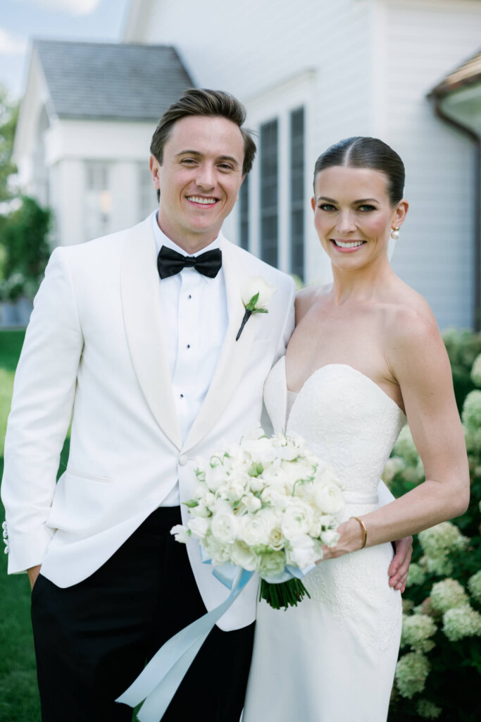 Bride and groom portrait in front of the white building in Bedford, New York