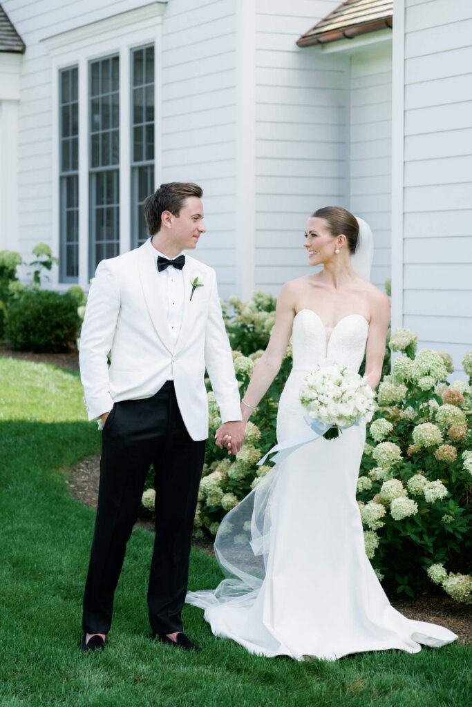 Bride and groom kissing before the ceremony at Bedford Golf and Tennis Club