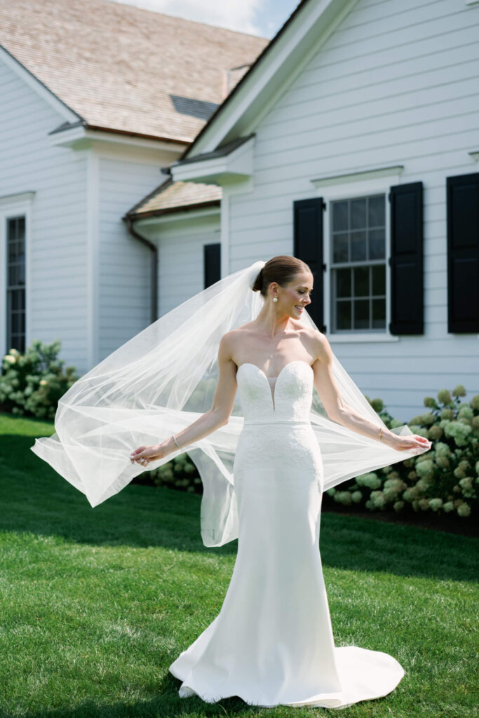 Bride and groom walking on the lawn at Bedford Golf and Tennis Club