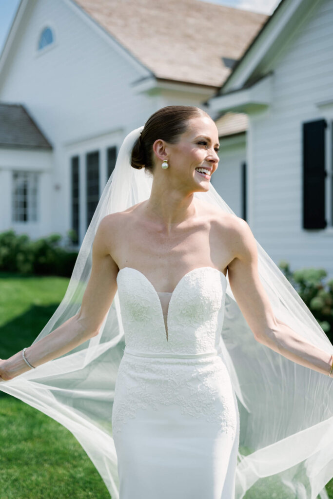 Bride and groom portrait with the white building before the Bedford wedding