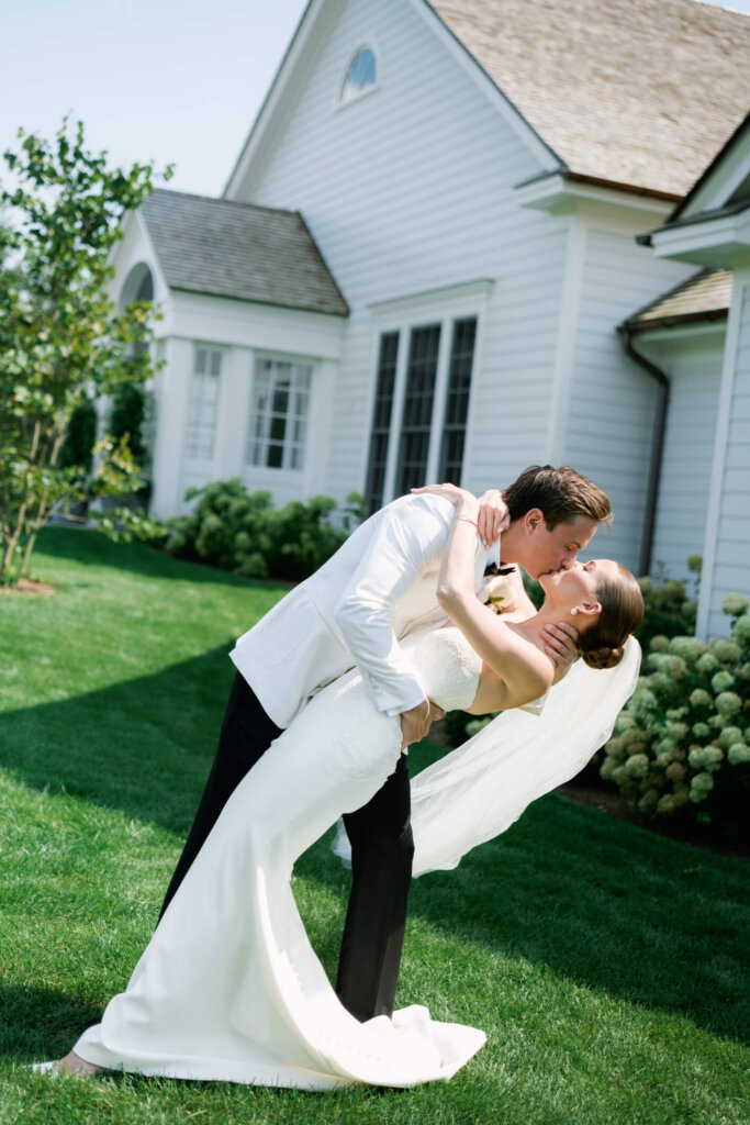 Bride and groom dipping in a portrait before the Bedford Golf and Tennis Club wedding