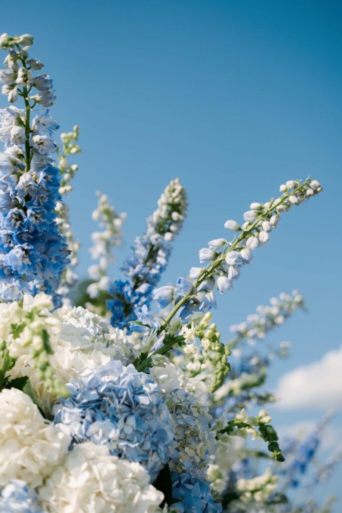 Ceremony florals and white chairs at Bedford Golf and Tennis Club