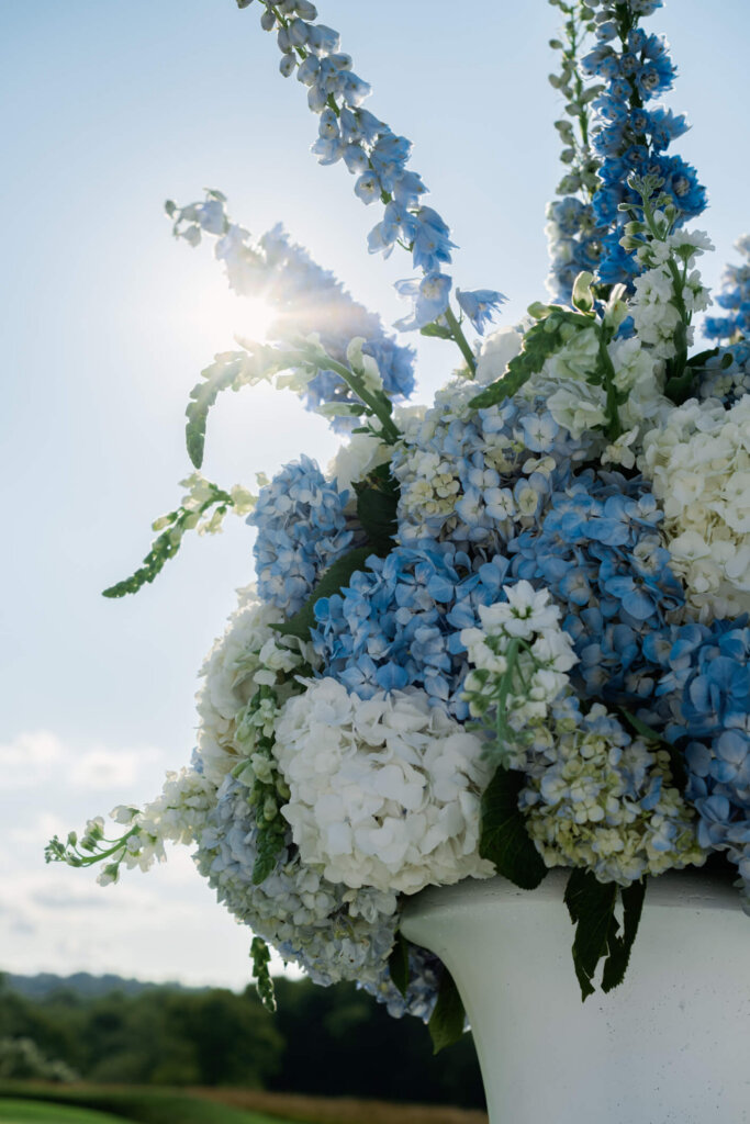 Blue and white floral arrangement in the sun at Bedford Golf and Tennis Club