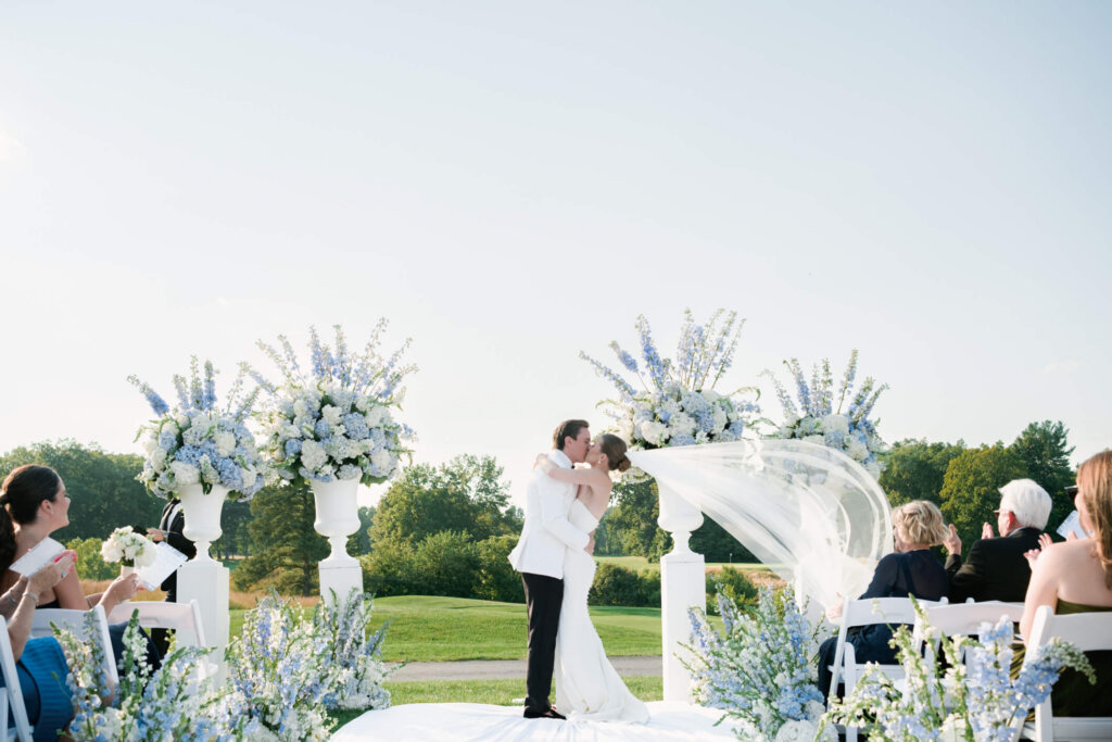 Bride and groom kissing at the altar during their Bedford Golf and Tennis Club ceremony