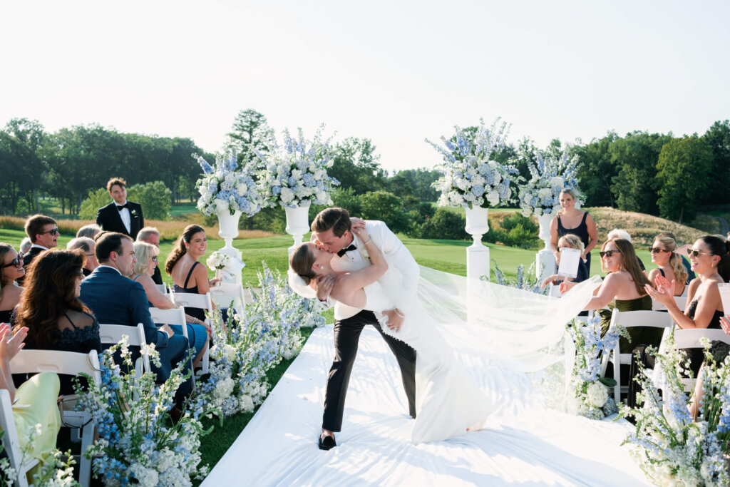 Bride and groom first kiss during their Bedford Golf and Tennis Club wedding