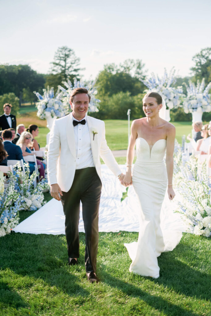 Bride and groom walking back down the aisle after their Bedford Golf and Tennis Club ceremony
